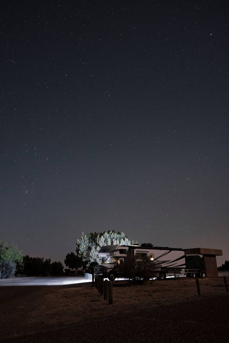 An RV under a starry night sky